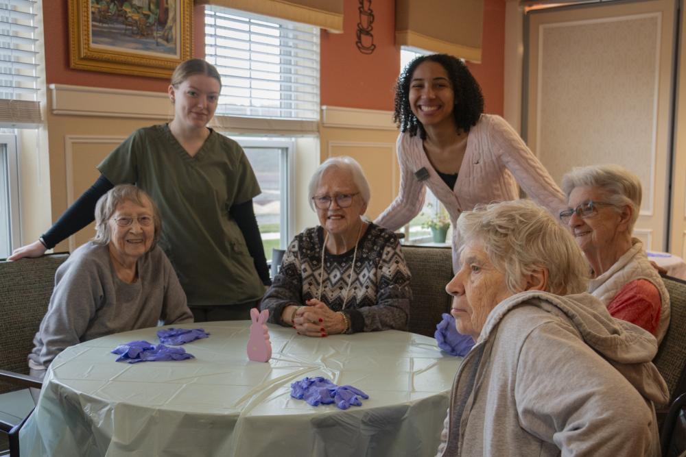 Residents at the table, Rosalie, Patty, Irene and Noreen. Lilly Taylor, Assistant, and Ranie Baptiste, Activities Coordinator. Photos by  Gerrelle Baldwin