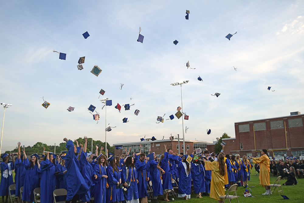 The graduates tossing their caps in the air. Photos by Kat Sheridan