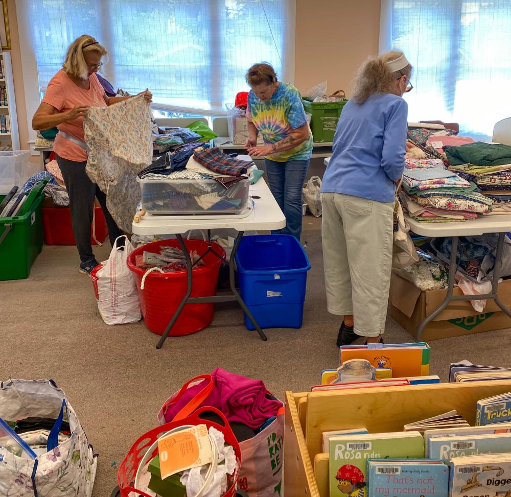 From left to right, Louise Paolella, Harriet Green and Maureen Cunningham measure and sort fabric. Photos by Sue Jackson