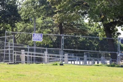 Fabricated metal fencing, a possible final touch on the project,  sits behind construction barricades. 
