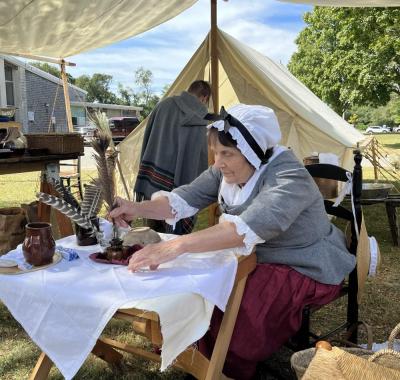 Cathy Potter mans the quill pen writing booth. She said most people that came to the booth had never written with a feather before. “They wrote the Declaration of Independence with a feather, so they get a history lesson with my featherwriting,” she said.
