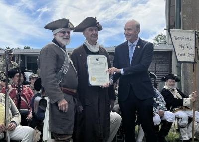 Keating presents the Minutemen with an official recognition certificate from the House.