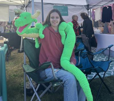Elisa Campanini shows off her handmade dragon puppet.