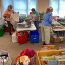 From left to right, Louise Paolella, Harriet Green and Maureen Cunningham measure and sort fabric. Photos by Sue Jackson