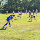 A field hockey player hits the ball during the 4-0 loss. Photo by Christian Uva