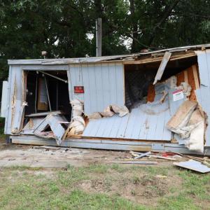 The front of a utility shed behind the 7-Eleven was caved in after a car slammed into it early morning on Monday, Aug. 3. Photos by Nick Mossman