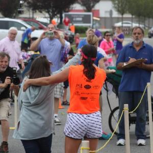 Racers cross the finish line during the 2017 Lazy Lobster road race. File photo