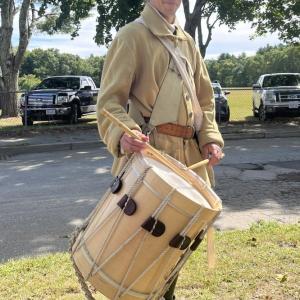 A drummer from the fife and drum corps. During the ceremony, U.S. Rep William Keating said the corps was used as a method of communication, such as signalling when to wake up or emergencies on the field.