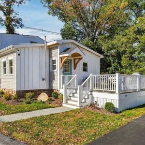 Front of 226 Sanford Road in North Westport, MA: a two-story home with board and batten siding and a front deck