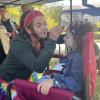 Beth Kelly from Art on the Spot paints a Spiderman design on a young girl's face. She has been facepainting for 15 years. Photos by Tanvi Kulkarni